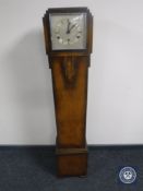 An oak Art Deco granddaughter clock with silvered dial