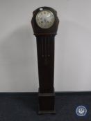 An oak granddaughter clock with silvered dial