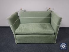 A 20th century drop-end settee upholstered in a green corded fabric