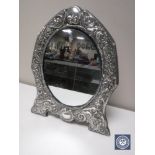 A large silver framed easel mirror