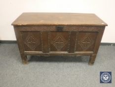An early 19th century panelled oak coffer,