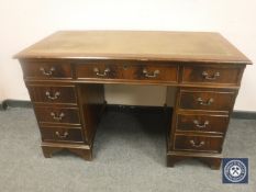A Georgian style mahogany desk with tooled leather top,