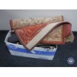 A box containing assorted woollen rugs