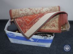 A box containing assorted woollen rugs