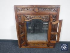 An Eastern hardwood mirror with shutter doors