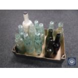 A box containing twelve vintage glass bottles together with a stoneware bottle