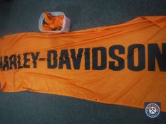 A box containing four Harley Davidson flags and banners