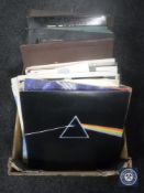 A box of LP records and singles including Pink Floyd