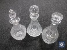 Three crystal decanters with stoppers