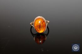 A 9ct gold amber dress ring, size J.