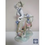 A Lladro figure of a man with a donkey CONDITION REPORT: Chip to man's hat which has