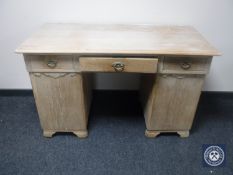 A continental oak twin pedestal writing desk