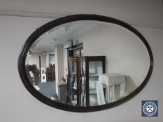 An early 20th century mahogany framed oval mirror