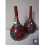 A pair of red floral pottery vases,