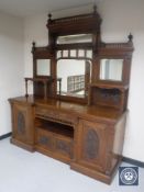 An impressive Victorian mahogany inverted breakfront mirror back sideboard with carved panel doors