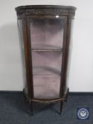 A continental demi-lune display cabinet with gilt metal mounts
