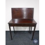 A 19th century mahogany turnover top tea table