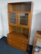 A twentieth century teak bookcase fitted with three drawers beneath