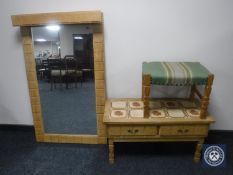 A blond oak wall mirror together with a tiled top low table and an upholstered dressing table stool