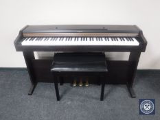 A Roland electric piano with stool