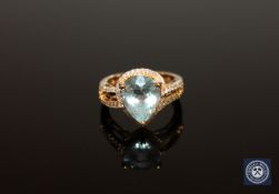 A 14ct white gold aquamarine and diamond ring, the pear-cut aquamarine weighing 4.