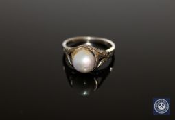 An early twentieth century pearl ring mounted in white metal stamped 18K, size I.