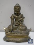 An antique lacquered brass figure of an Eastern deity