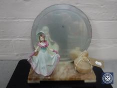 An Art Deco marble mirrored back table stand with lidded trinket pot and a figure of a lady