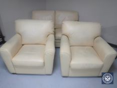 A three piece cream leather lounge suite with footstool