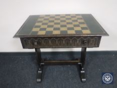 An oak chessboard table, part of The Tower of London Chess Set, made by John D.