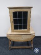 A blonde oak drop leaf coffee table and a wall cabinet