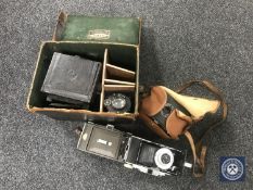 A tray of vintage leather cased box camera with optics and three other cameras