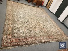 An Iranian Tabriz design carpet, 470cm by 403cm CONDITION REPORT: Pile worn thin.