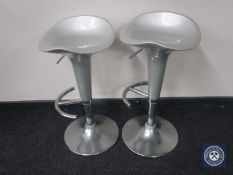 A pair of gas lift bar stools