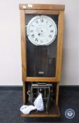 An oak cased clocking in machine by The Gledhill-Brooke Time Recorders Limited
