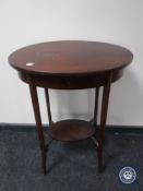 An antique oval mahogany work table