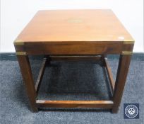 A mahogany campaign style lamp table with brass mounts