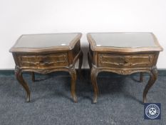 A pair of continental oak bedside tables fitted a drawer