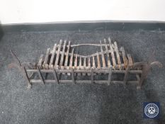 An antique cast iron fire front and grate
