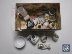 A box containing assorted tourist china and a china dolly top
