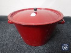 A red enamelled cooking pot with lid