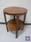 A circular oak revolving two tier table