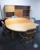 A 1970s seven piece teak dining room suite