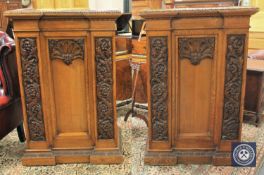 A pair of Edwardian panelled and carved oak inverted breakfront auctioneer's rostrums,