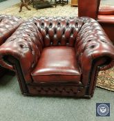 A Chesterfield style oxblood buttoned leather club armchair,