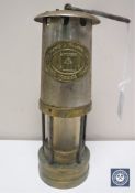 A brass and chrome cased miner's lamp by E Thomas & Williams Ltd
