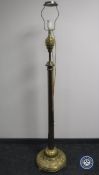 An antique brass standard lamp