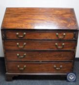 A George III mahogany bureau on bracket feet