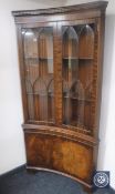 A mahogany inverted break-front double door display cabinet