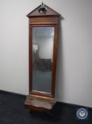 An antique continental hall mirror with shelf